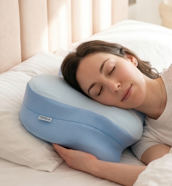 A woman sleeping calmly on a light blue contour pillow